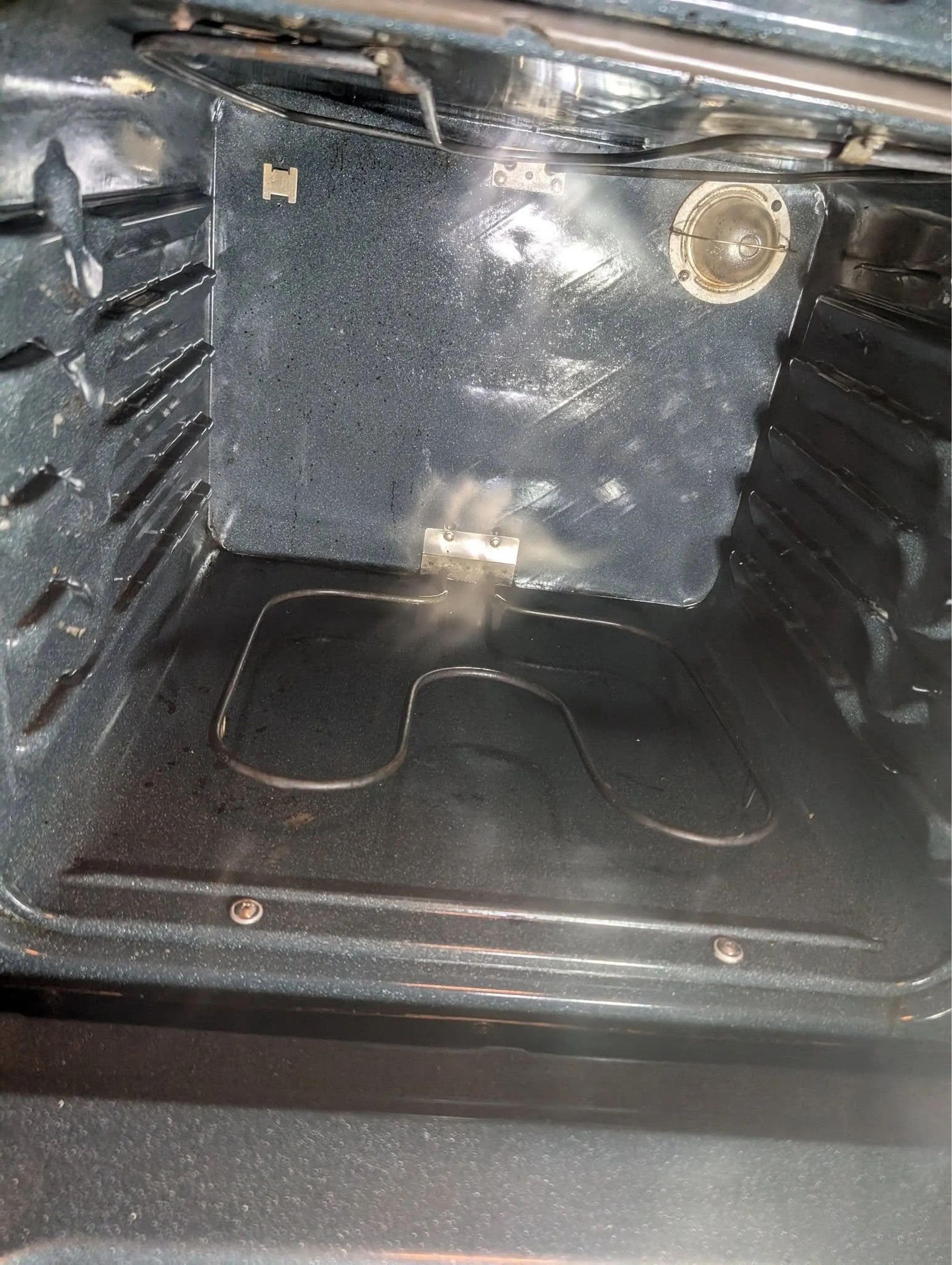 The same oven interior after cleaning, with clean walls and floor
