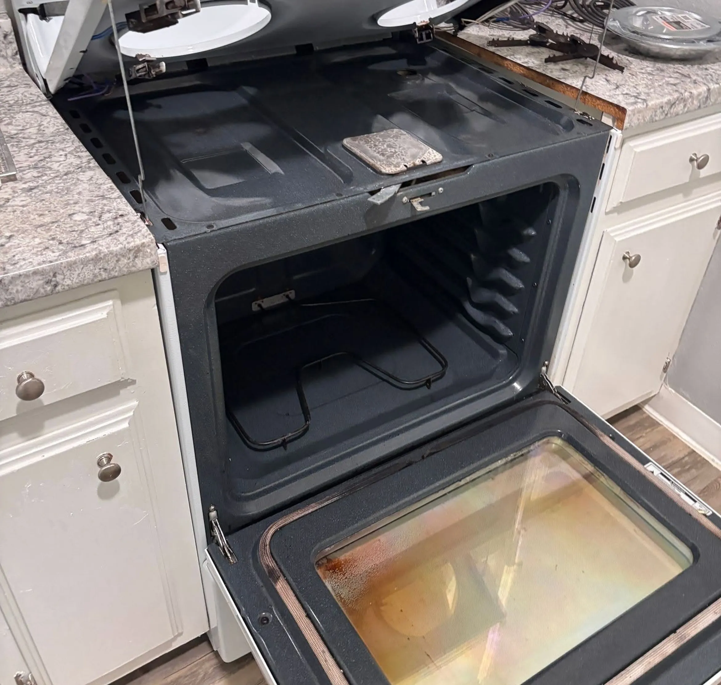 The same range after deep cleaning, with a spotless cooktop well and clean oven interior
