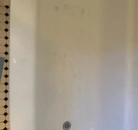 The same shower wall after cleaning, clean and bright